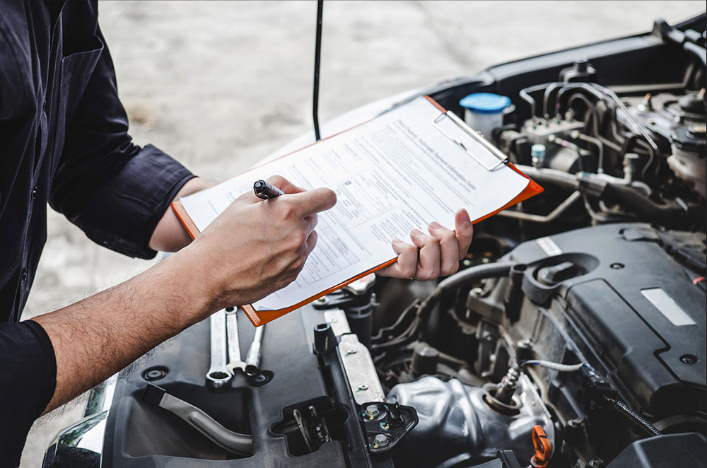 Technician performing mechanical and body repair at GB Auto